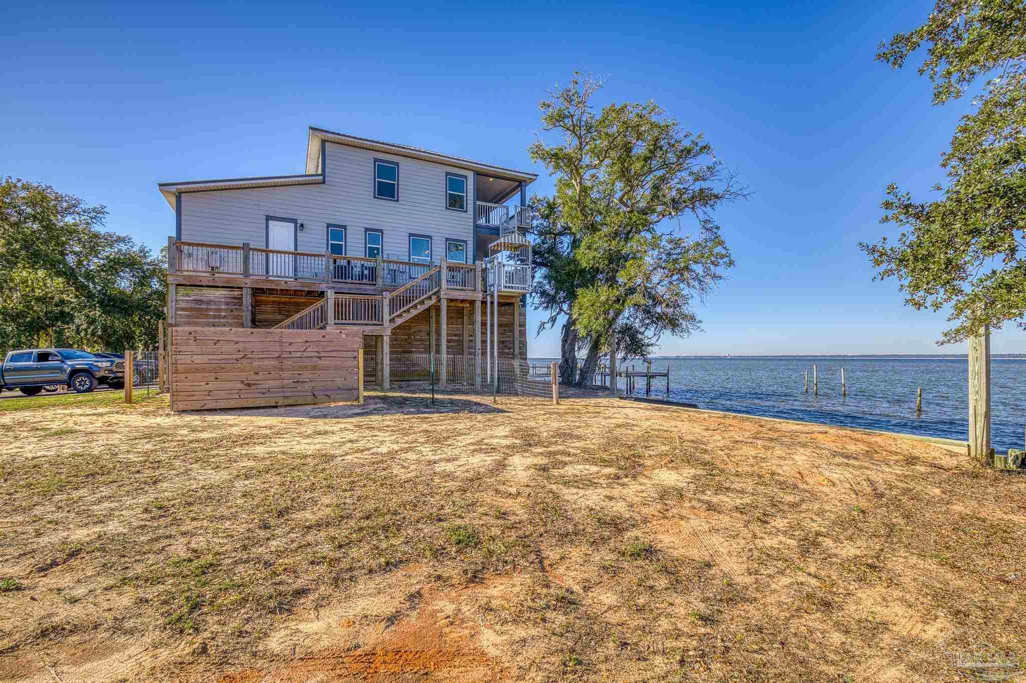 305 Garcon Point Road Milton, FL 32583 - Photo 53 of 72 a front view of a house with a yard and garage