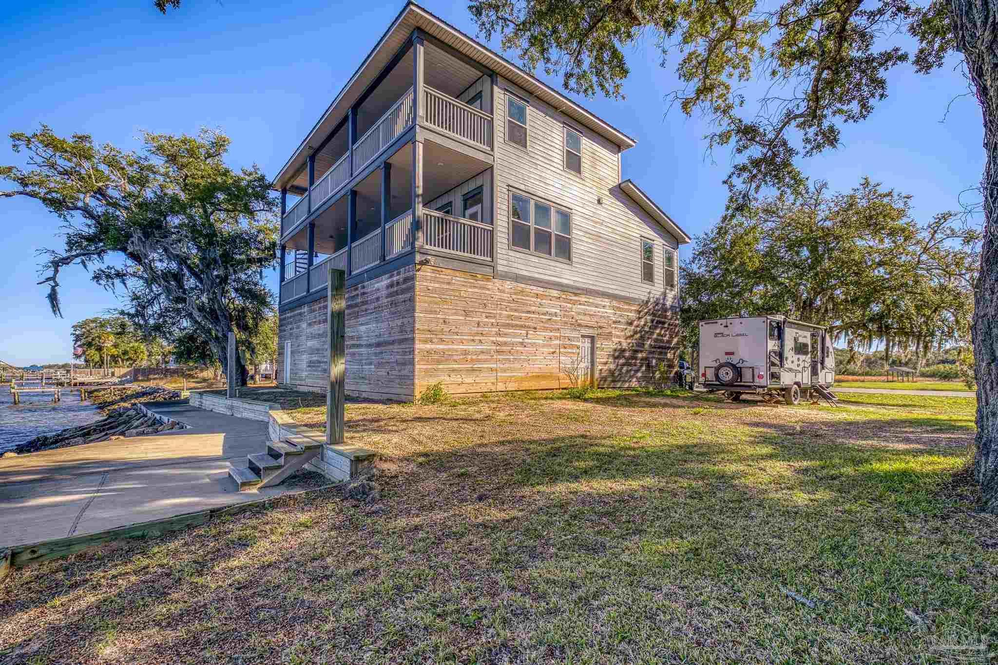 305 Garcon Point Road Milton, FL 32583 - Photo 58 of 72 a view of a house with a yard