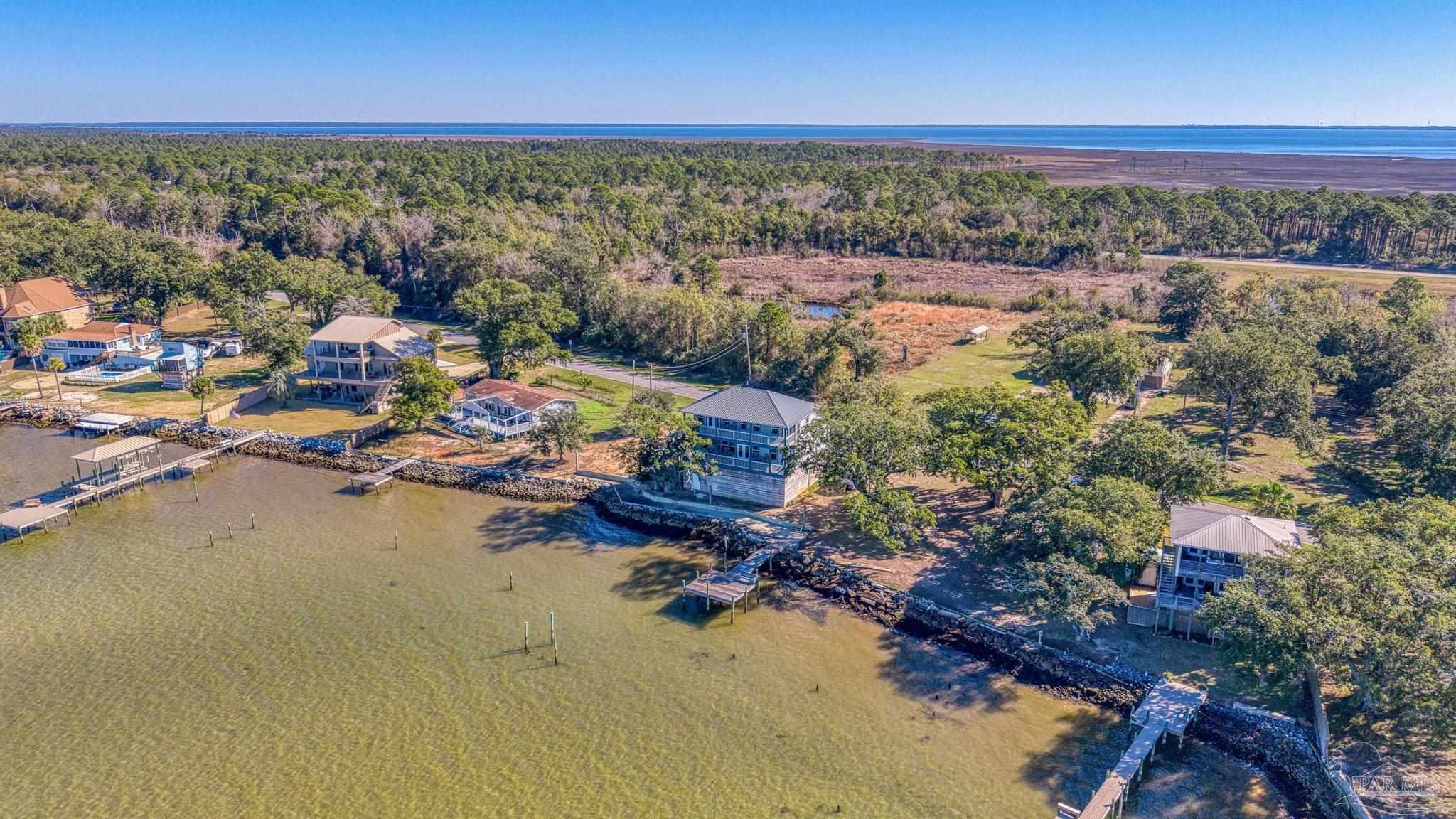 305 Garcon Point Road Milton, FL 32583 - Photo 67 of 72 an aerial view of a city with lots of residential buildings ocean and mountain view in back