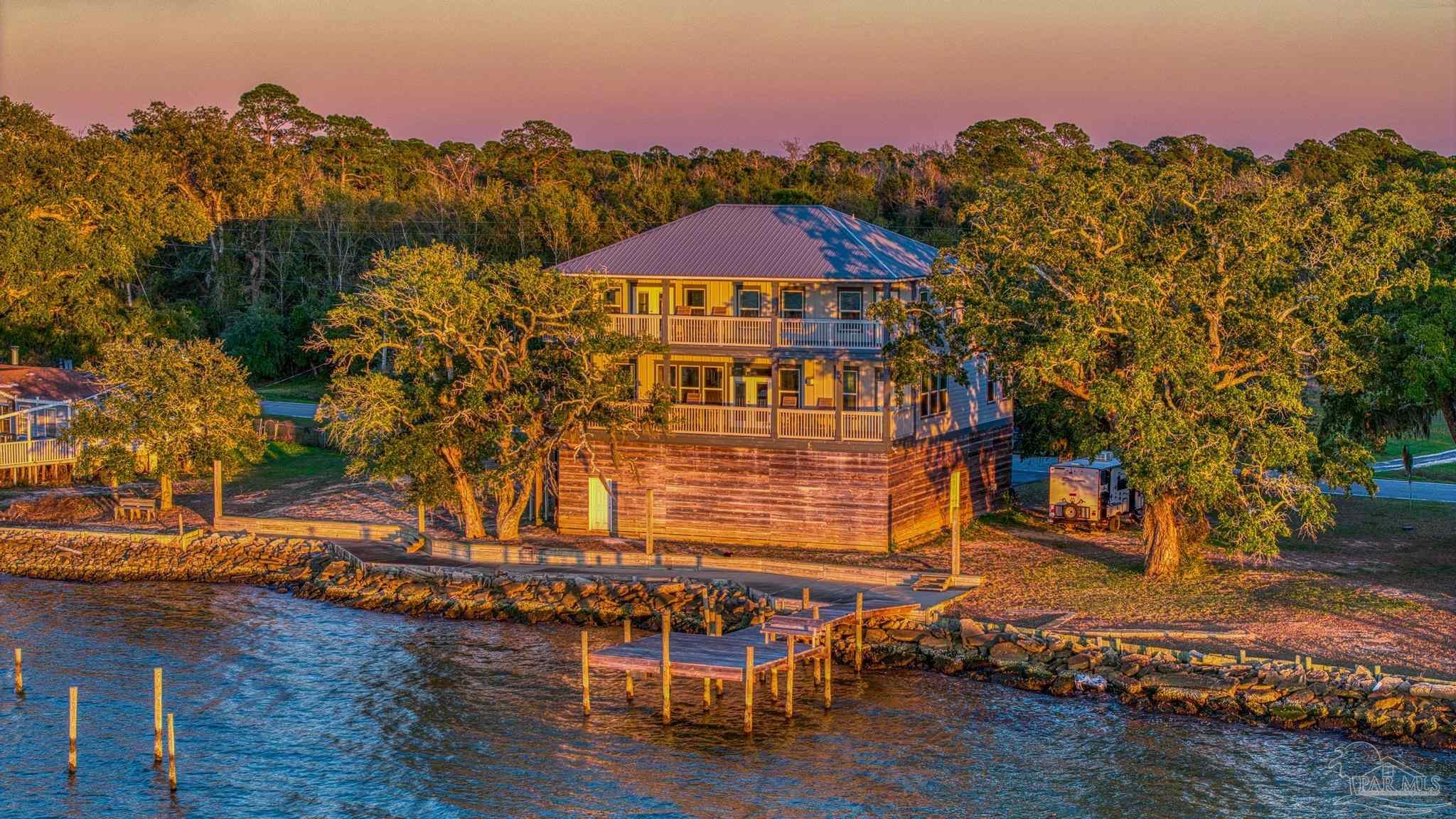 305 Garcon Point Road Milton, FL 32583 - Photo 71 of 72 a view of a swimming pool with an outdoor seating