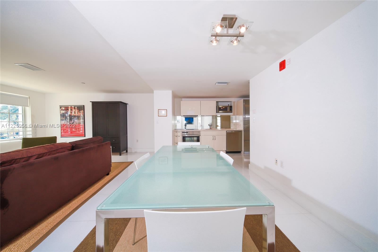 Flamingo-Lummus Miami Beach, FL 33139 - Photo 12 of 28 a room with stainless steel appliances kitchen island a table and chairs in it