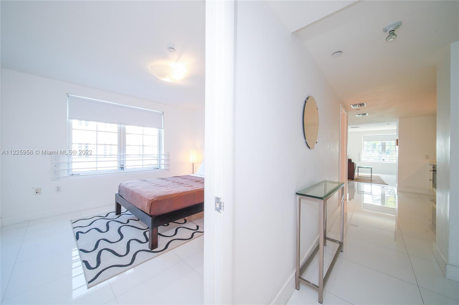 Flamingo-Lummus Miami Beach, FL 33139 - Photo 22 of 28 a living room with furniture a window and a chandelier