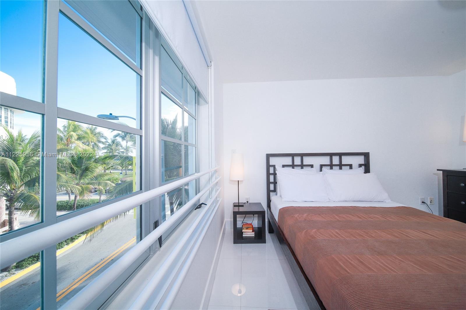 Flamingo-Lummus Miami Beach, FL 33139 - Photo 24 of 28 a bedroom with a large bed and a large window