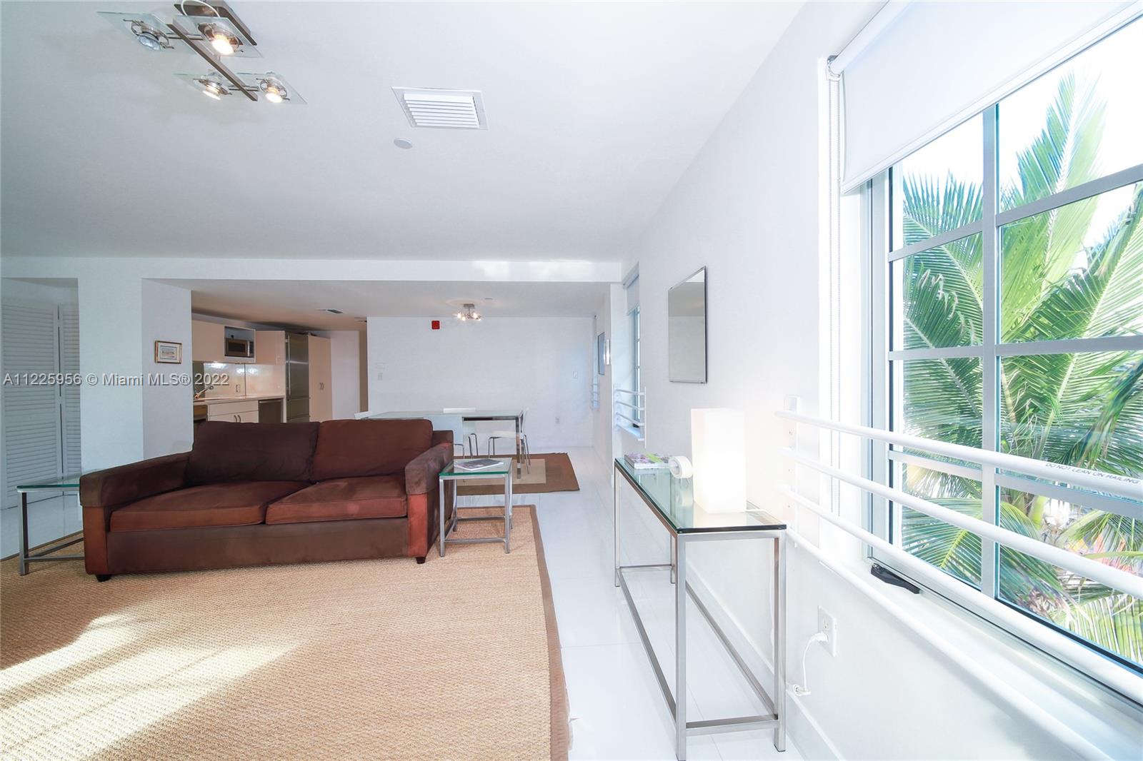 Flamingo-Lummus Miami Beach, FL 33139 - Photo 8 of 28 a living room with furniture and a large window
