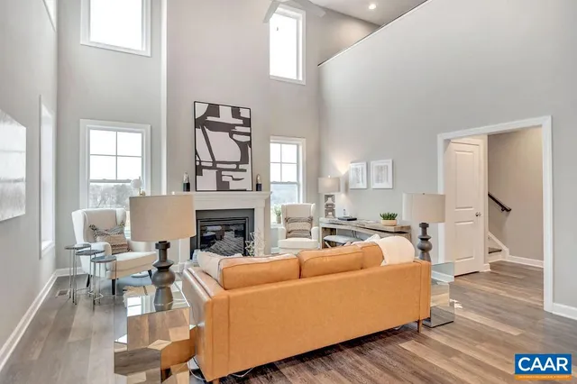 a kitchen with stainless steel appliances a dining table chairs refrigerator and sink