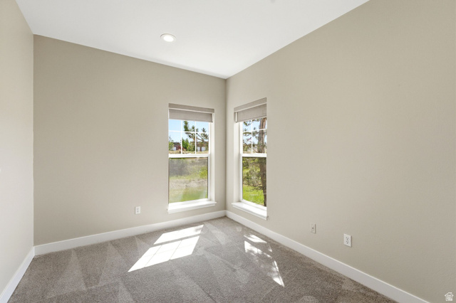 900 Bitner Road, Unit P17 Park City, UT 84098 - Photo 21 of 45 Neutral-toned walls complement the gray patterned carpet in this room featuring two windows with roller shades