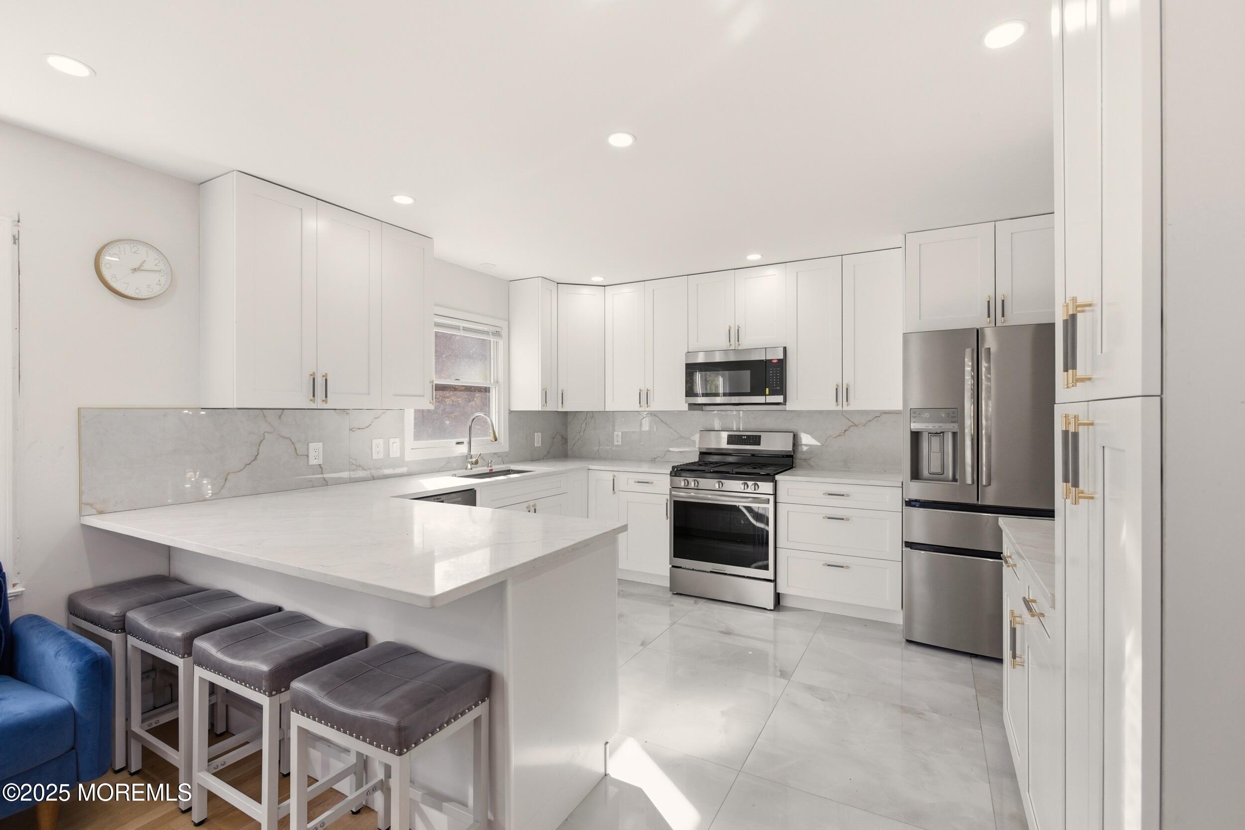 75 Hickory Hill Road Jackson, NJ 08527 - Photo 12 of 30 a kitchen with stainless steel appliances a refrigerator stove microwave and cabinets