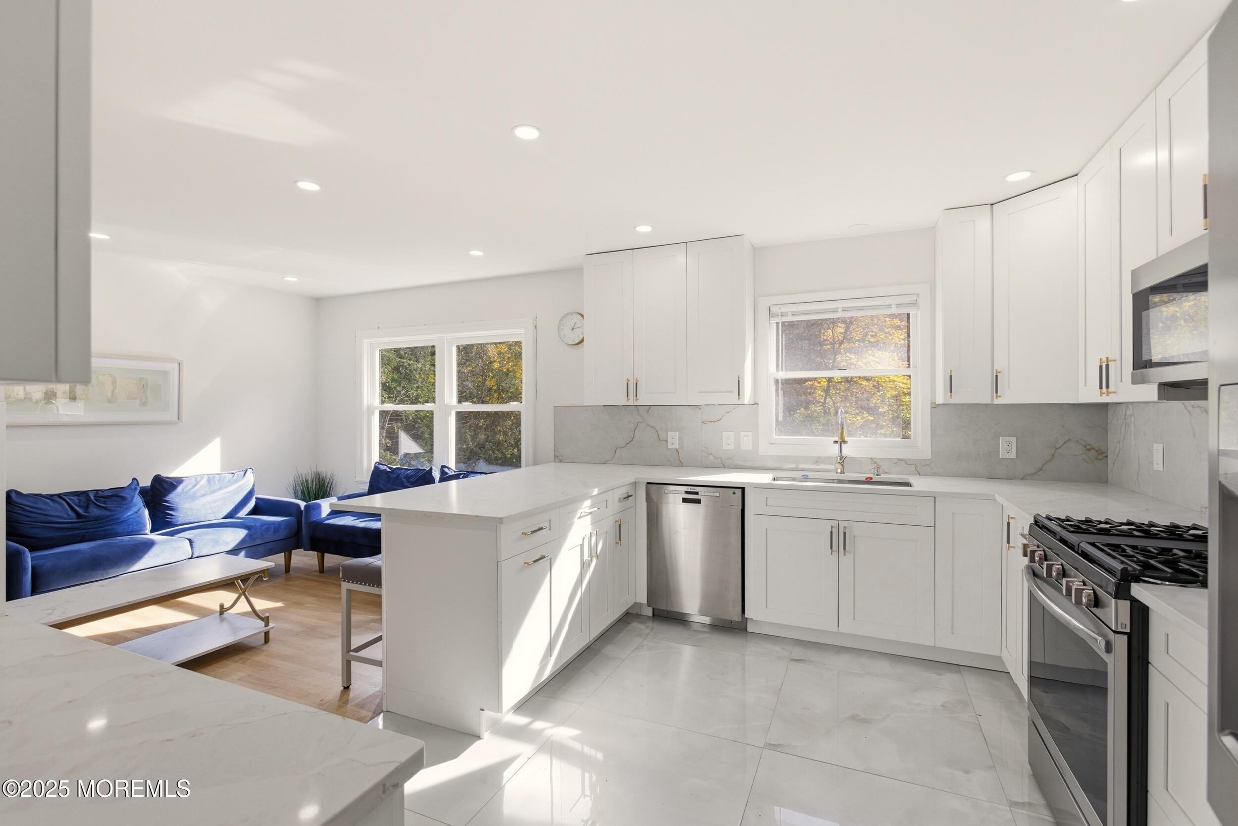 75 Hickory Hill Road Jackson, NJ 08527 - Photo 13 of 30 a kitchen with kitchen island granite countertop a sink and white cabinets