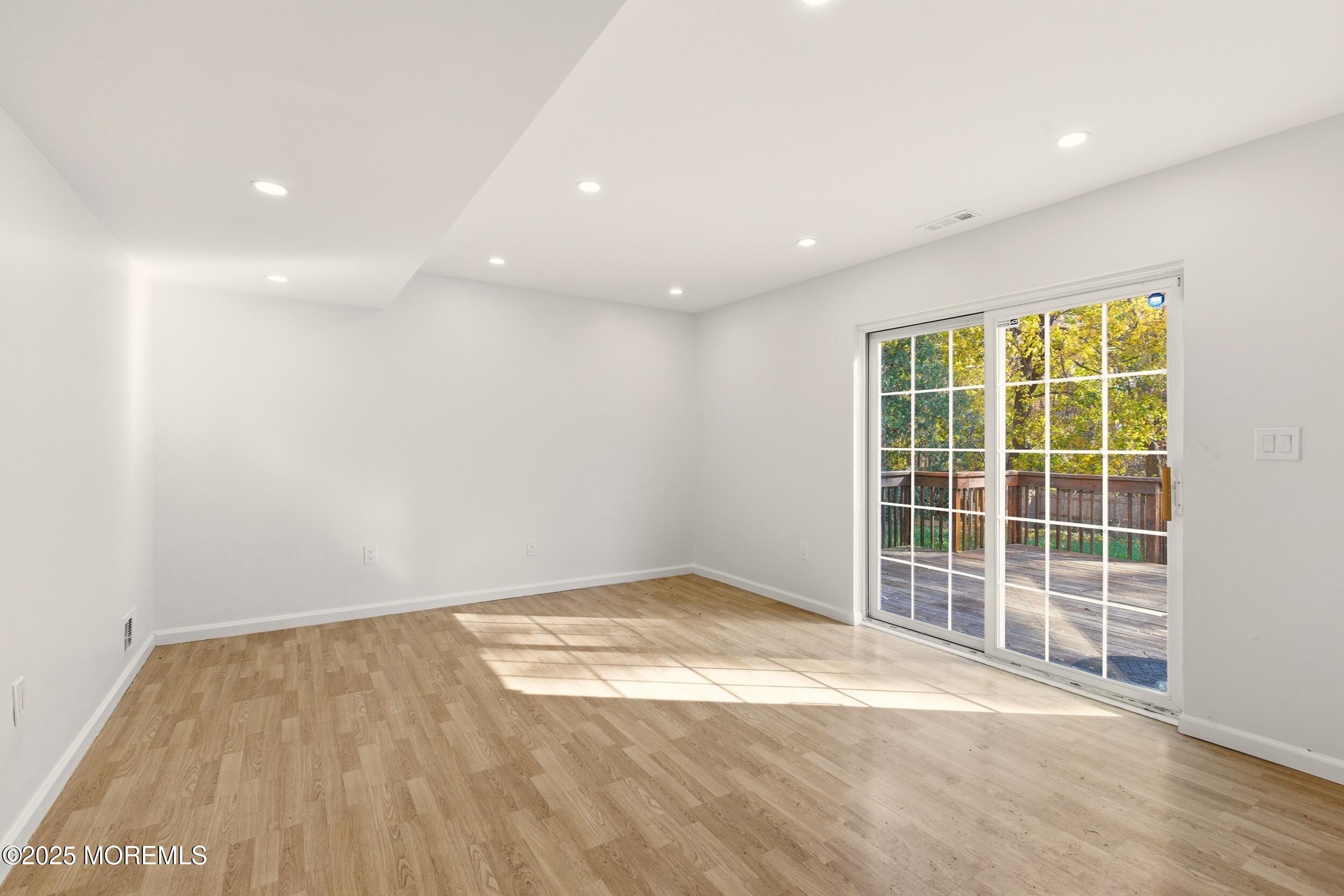 75 Hickory Hill Road Jackson, NJ 08527 - Photo 22 of 30 an empty room with wooden floor and windows
