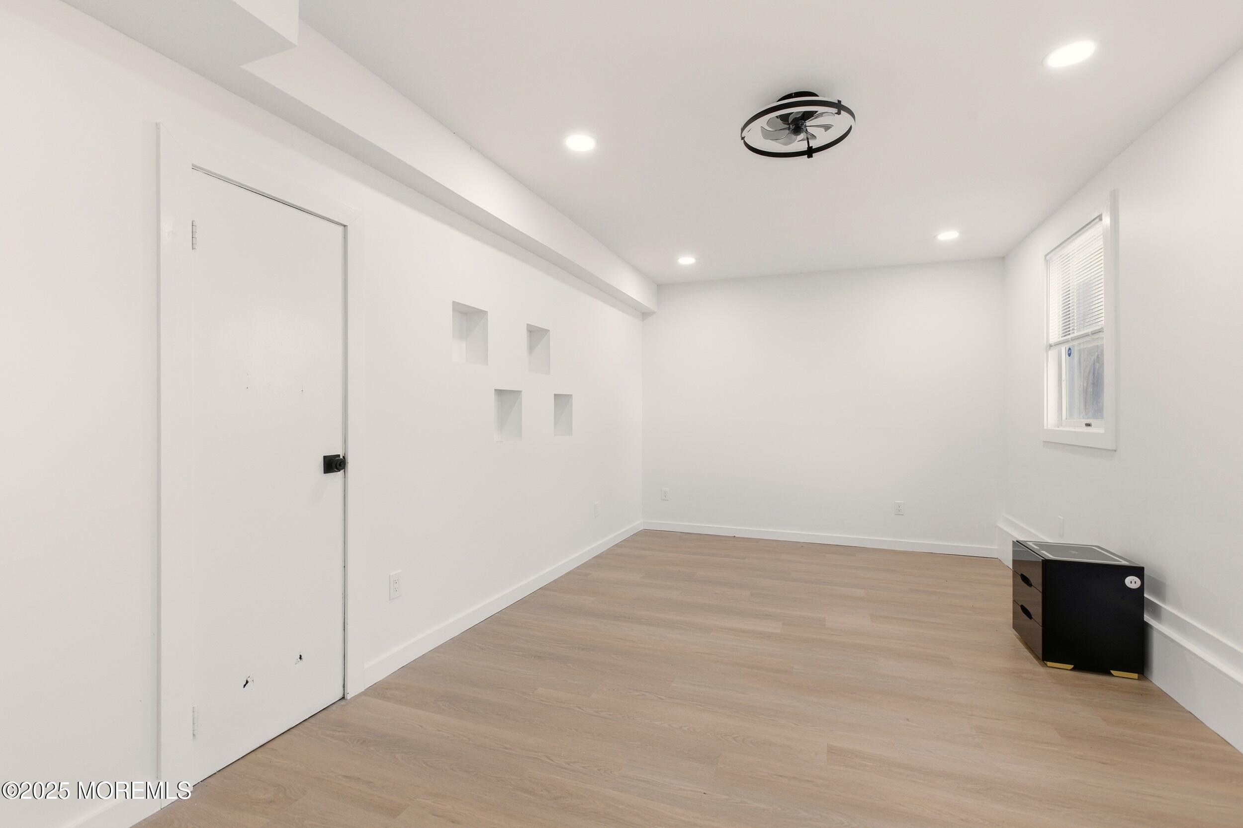 75 Hickory Hill Road Jackson, NJ 08527 - Photo 28 of 30 a view of an empty room with wooden floor and windows