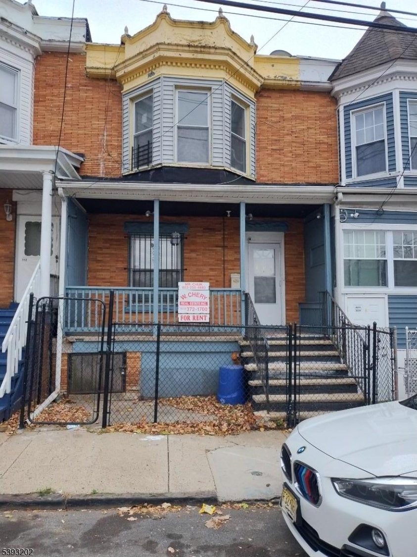 a front view of a house with stairs