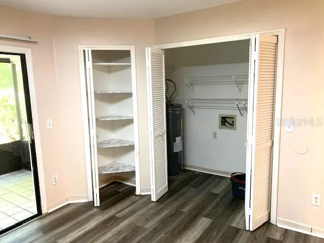 a view of a hallway with wooden floor and closet