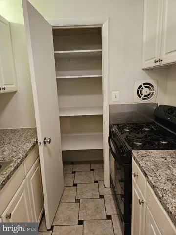 a kitchen with a stove and a cabinet