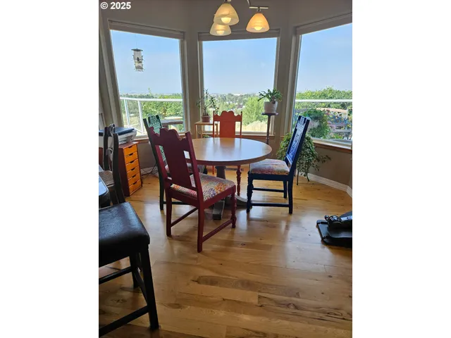 a dining room with furniture and wooden floor