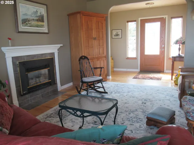 a living room with furniture a window and a fireplace