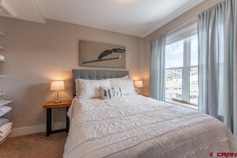 20 Marcellina Lane, Unit 104 Crested Butte, CO 81225 - Photo 20 of 28 a bedroom with a bed and a painting on the wall