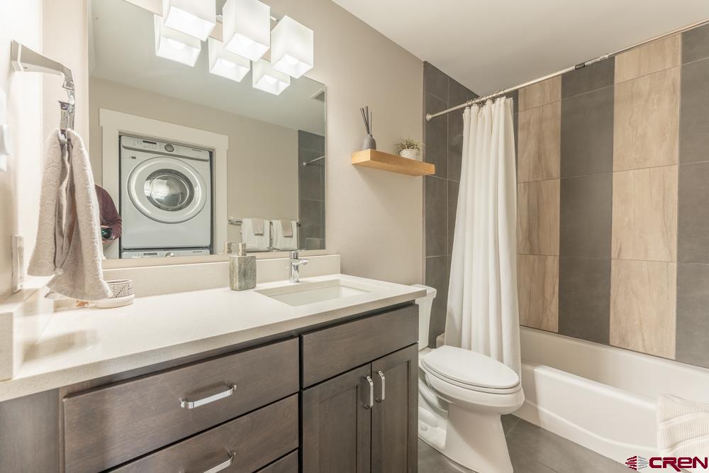 20 Marcellina Lane, Unit 104 Crested Butte, CO 81225 - Photo 9 of 28 a bathroom with a sink a toilet and a mirror