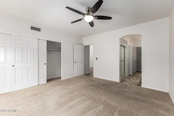 a spacious bathroom with a granite countertop sink mirror and a