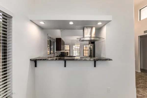 a kitchen with stainless steel appliances granite countertop a stove a refrigerator and a microwave