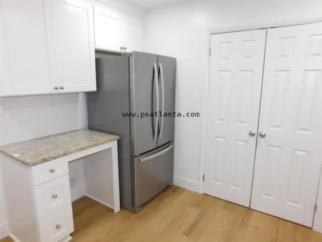 a kitchen with cabinets and stainless steel appliances