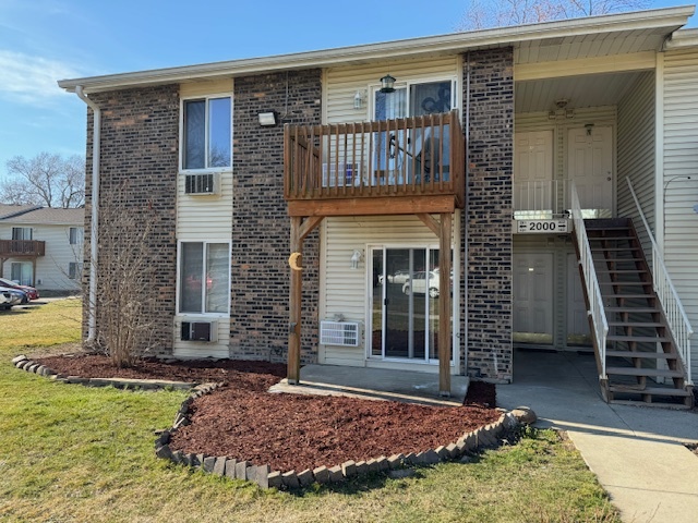 2000 Light Road, Unit 101 Oswego, IL 60543 - Photo 1 of 11 a front view of a house with garden