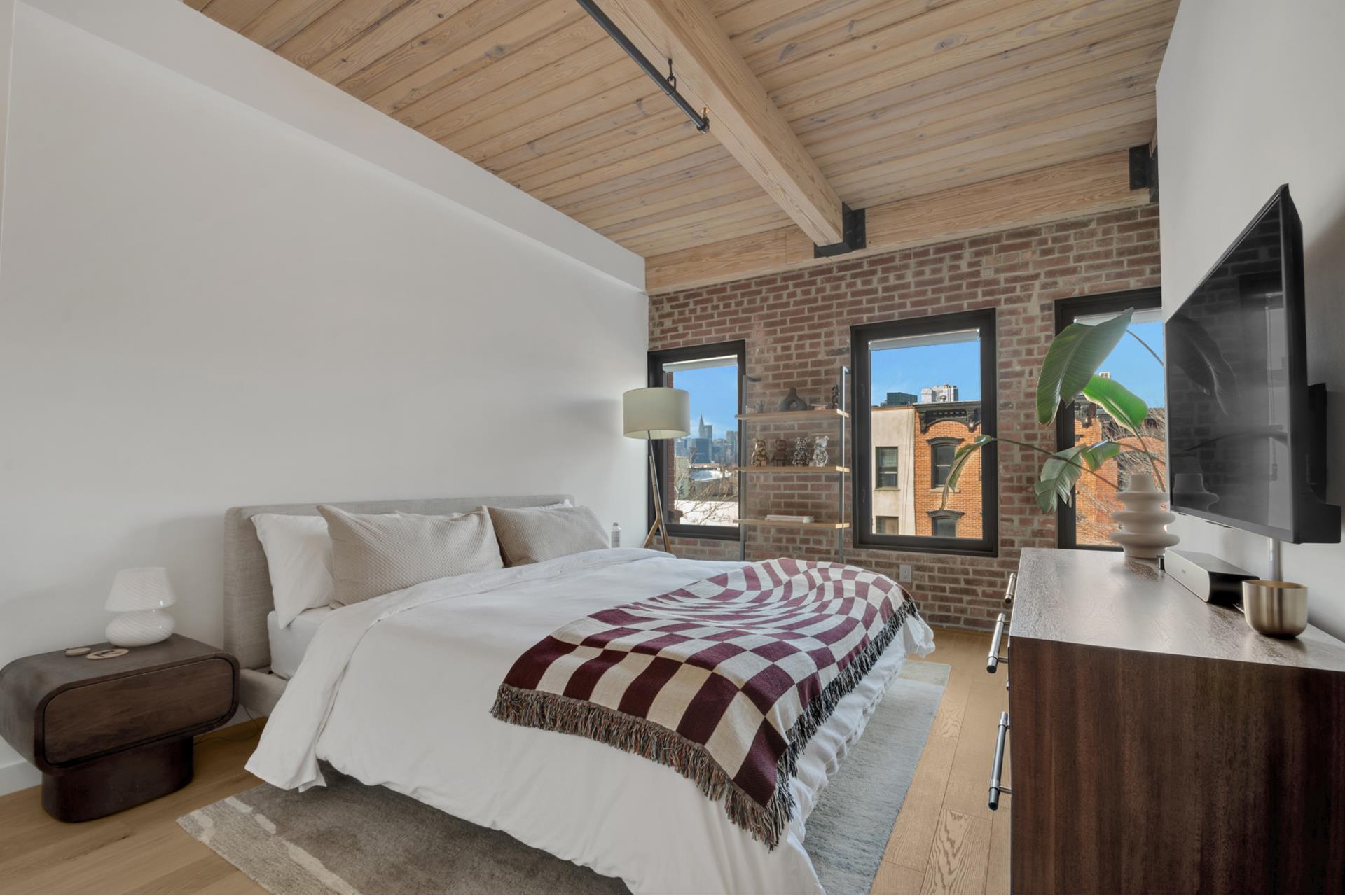 120 Java Street, Unit 4B Brooklyn, NY 11222 - Photo 12 of 27 a bedroom with a bed a large window and flat screen tv