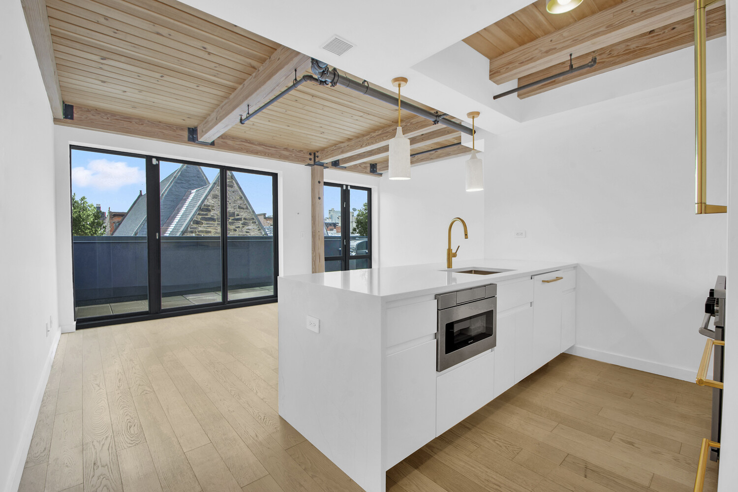a view of a kitchen with a sink and microwave