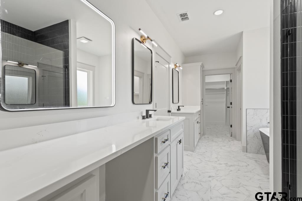 15837 Stillwaters Lindale, TX 75771 - Photo 23 of 32 a bathroom with a double vanity sink mirror and