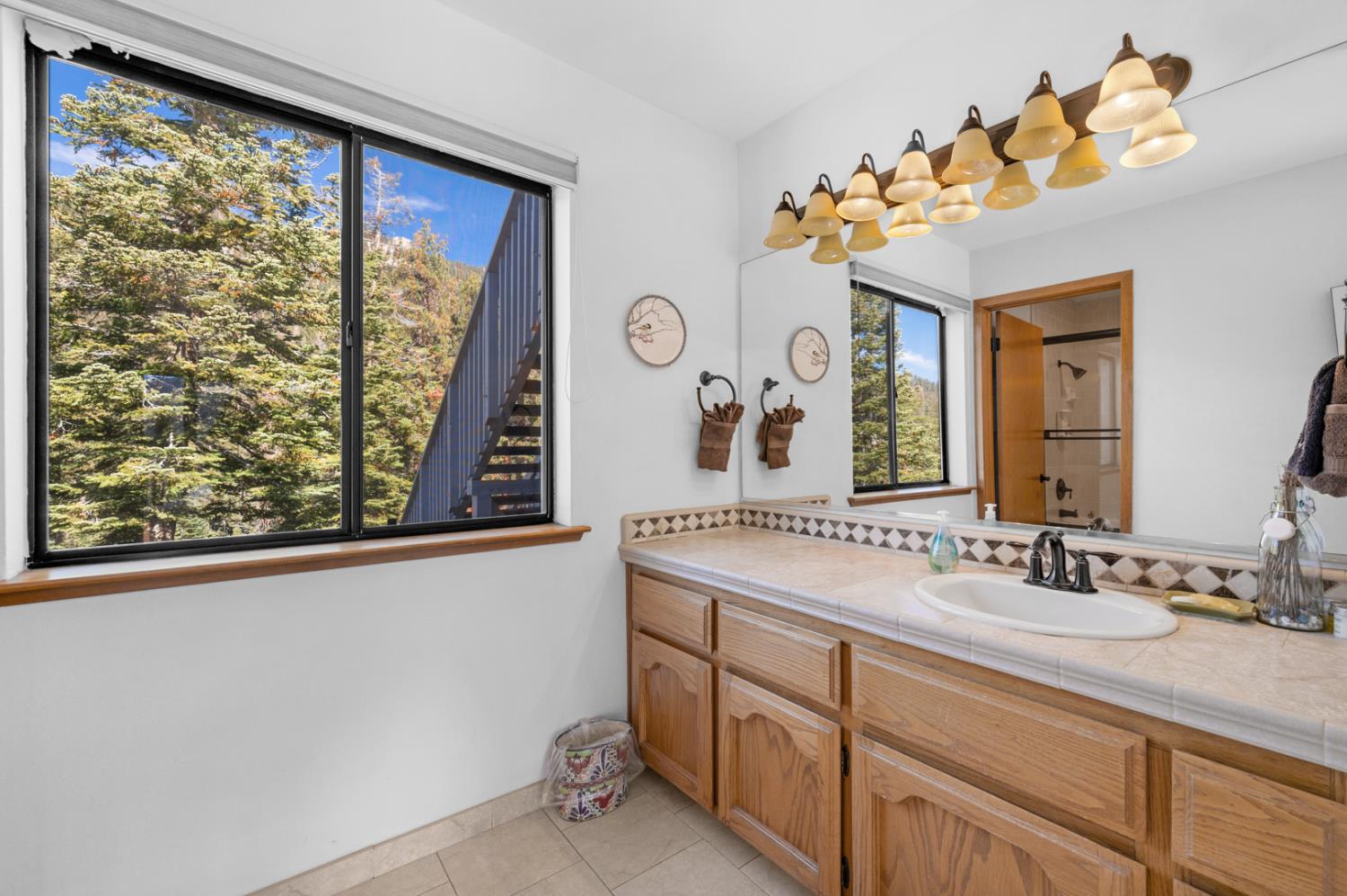 63215 Huntington Vista Road, Unit 80 Mono Hot Springs, CA 93642 - Photo 30 of 58 a bathroom with a sink mirror and a window
