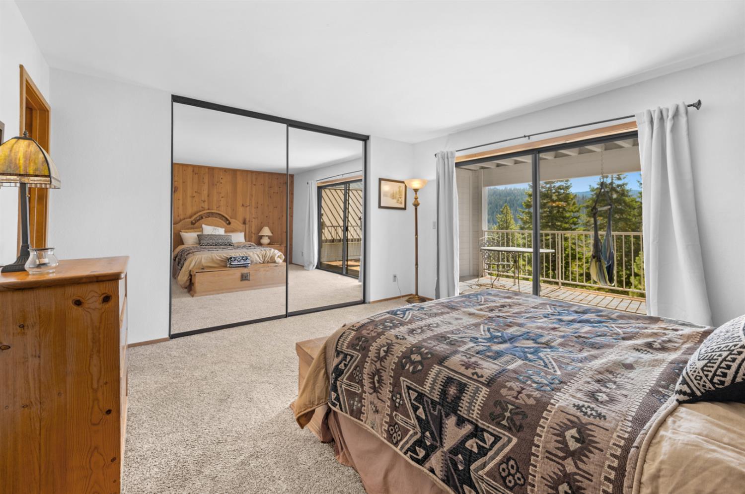 63215 Huntington Vista Road, Unit 80 Mono Hot Springs, CA 93642 - Photo 38 of 58 a bedroom with a bed and a large mirror next to a window