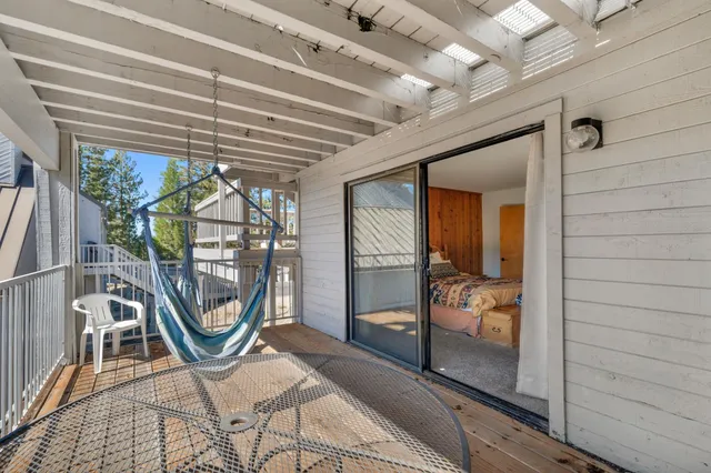 a view of a street with a yard and a large tree