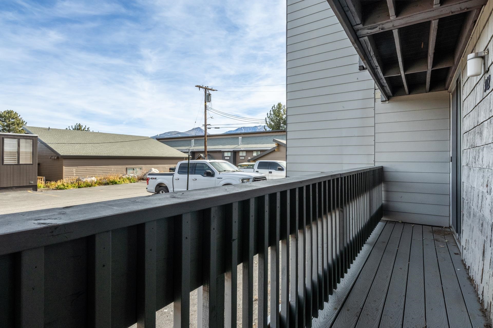 137 Laurel Mountain Road, Unit 312 Mammoth Lakes, CA 93546 - Photo 19 of 37 a view of a balcony with wooden floor and fence