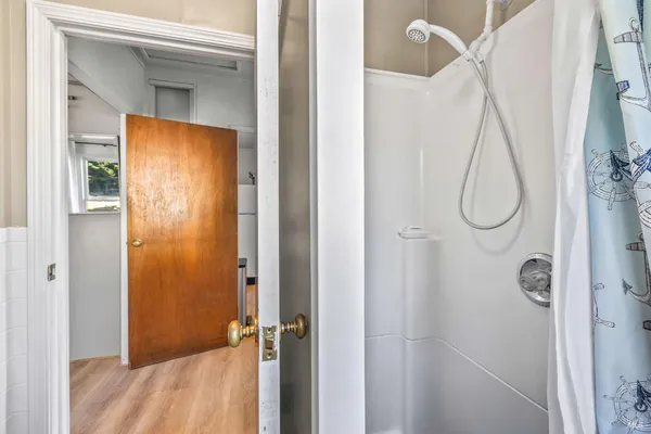 a bathroom with a glass shower door