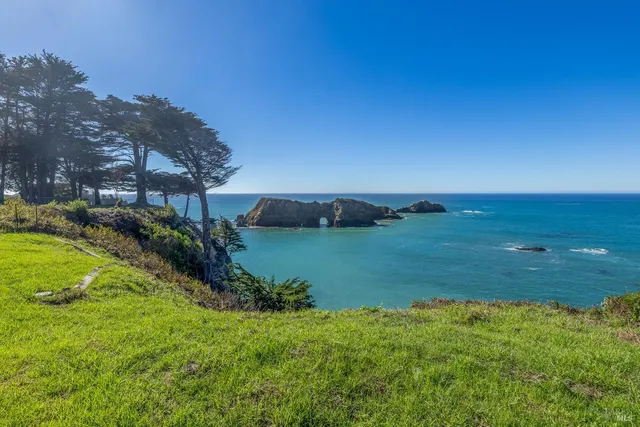 a view of a house with swimming pool and a yard