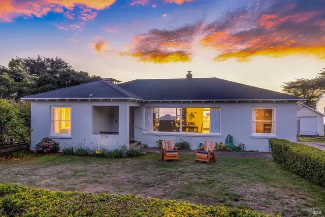 a view of a brick house with a yard