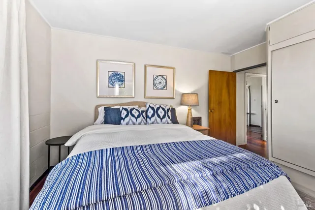 a bedroom with a large bed and a dresser