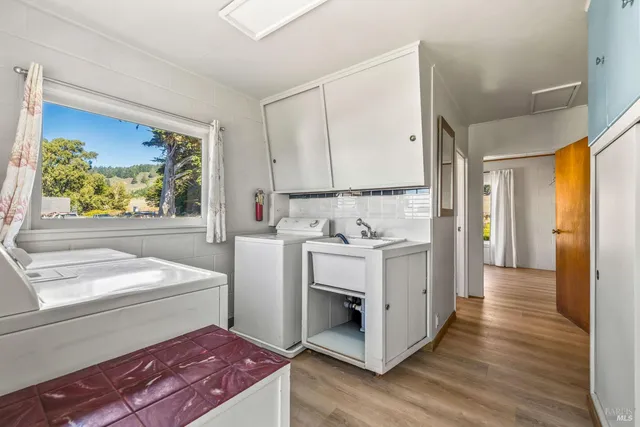 an aerial view of a house with a garden and lake view