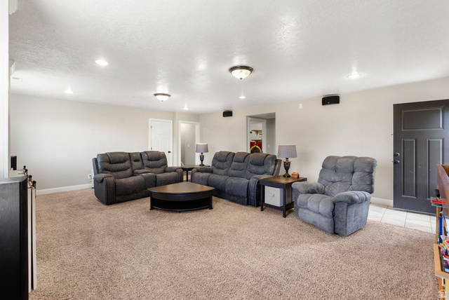 2485 South 1100th Street West Logan, UT 84321 - Photo 29 of 53 Spacious living area featuring neutral-toned carpeting, recessed lighting, and light-colored walls