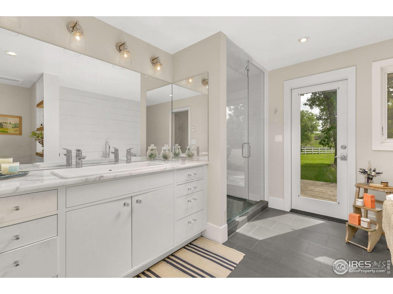 3858 57th Street Boulder, CO 80301 - Photo 16 of 39 a spacious bathroom with a shower a sink and a mirror