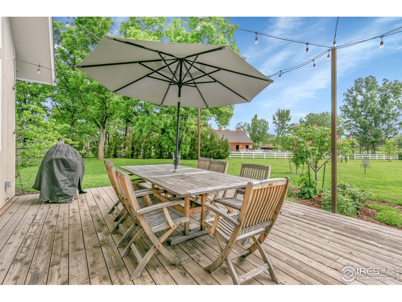 3858 57th Street Boulder, CO 80301 - Photo 31 of 39 a view of a patio with table and chairs under an umbrella
