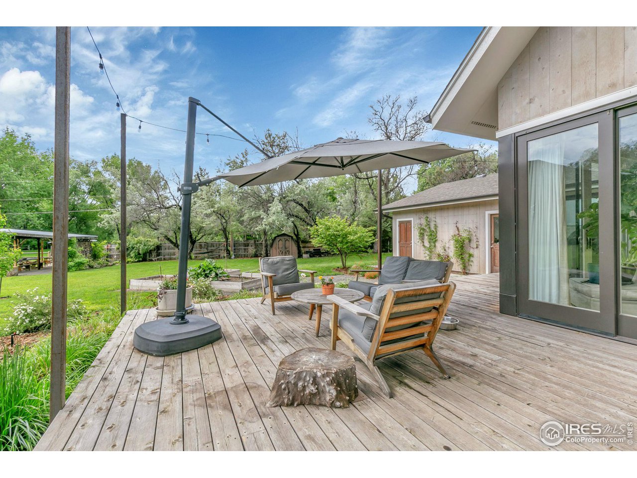 3858 57th Street Boulder, CO 80301 - Photo 32 of 39 a view of a patio with table and chairs potted plants with wooden floor and fence