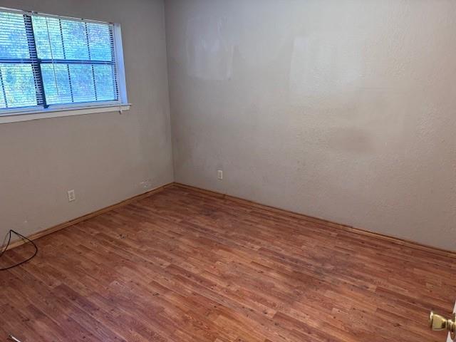 1017 12th Street Southeast, Unit 1017 Paris, TX 75460 - Photo 7 of 8 Unfurnished room featuring wood finished floors and baseboards
