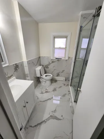 a bathroom with a glass shower door