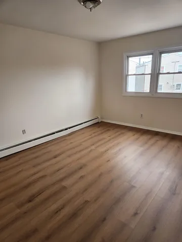 an empty room with wooden floor