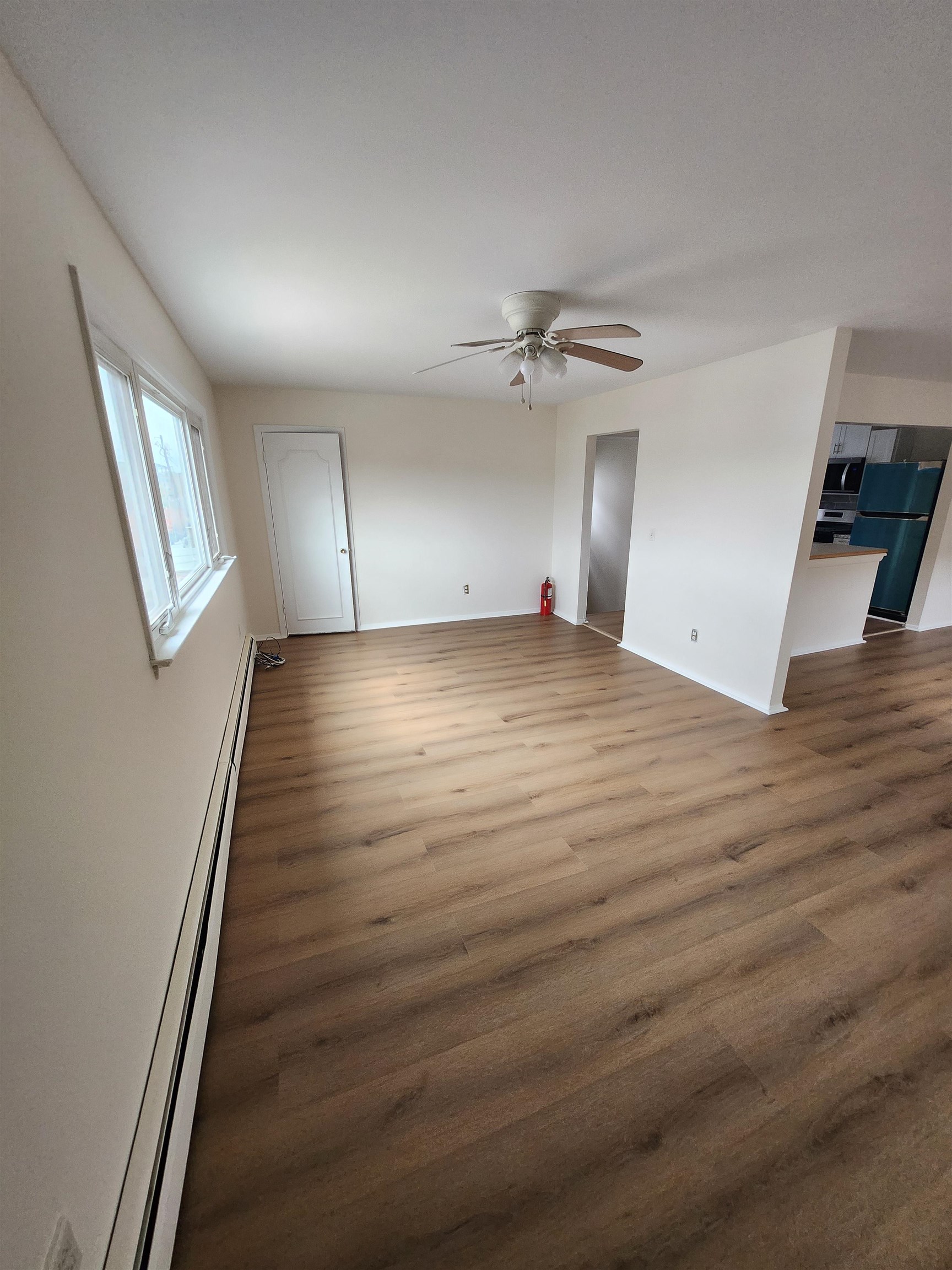 71 Linnet Street, Unit 2 Bayonne, NJ 07002 - Photo 4 of 18 wooden floor in an empty room with a window