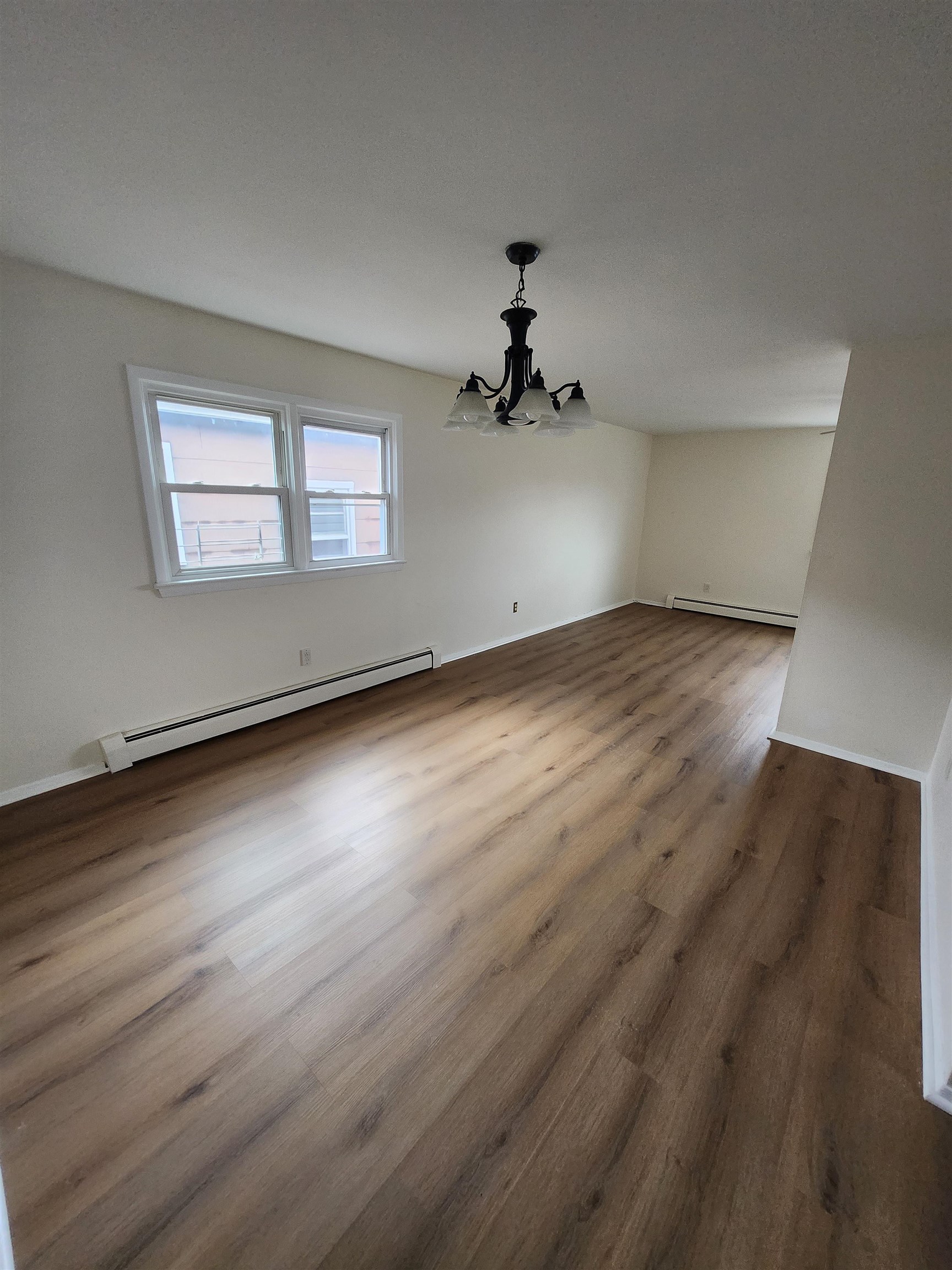 71 Linnet Street, Unit 2 Bayonne, NJ 07002 - Photo 5 of 18 a view of empty room with wooden floor and fan
