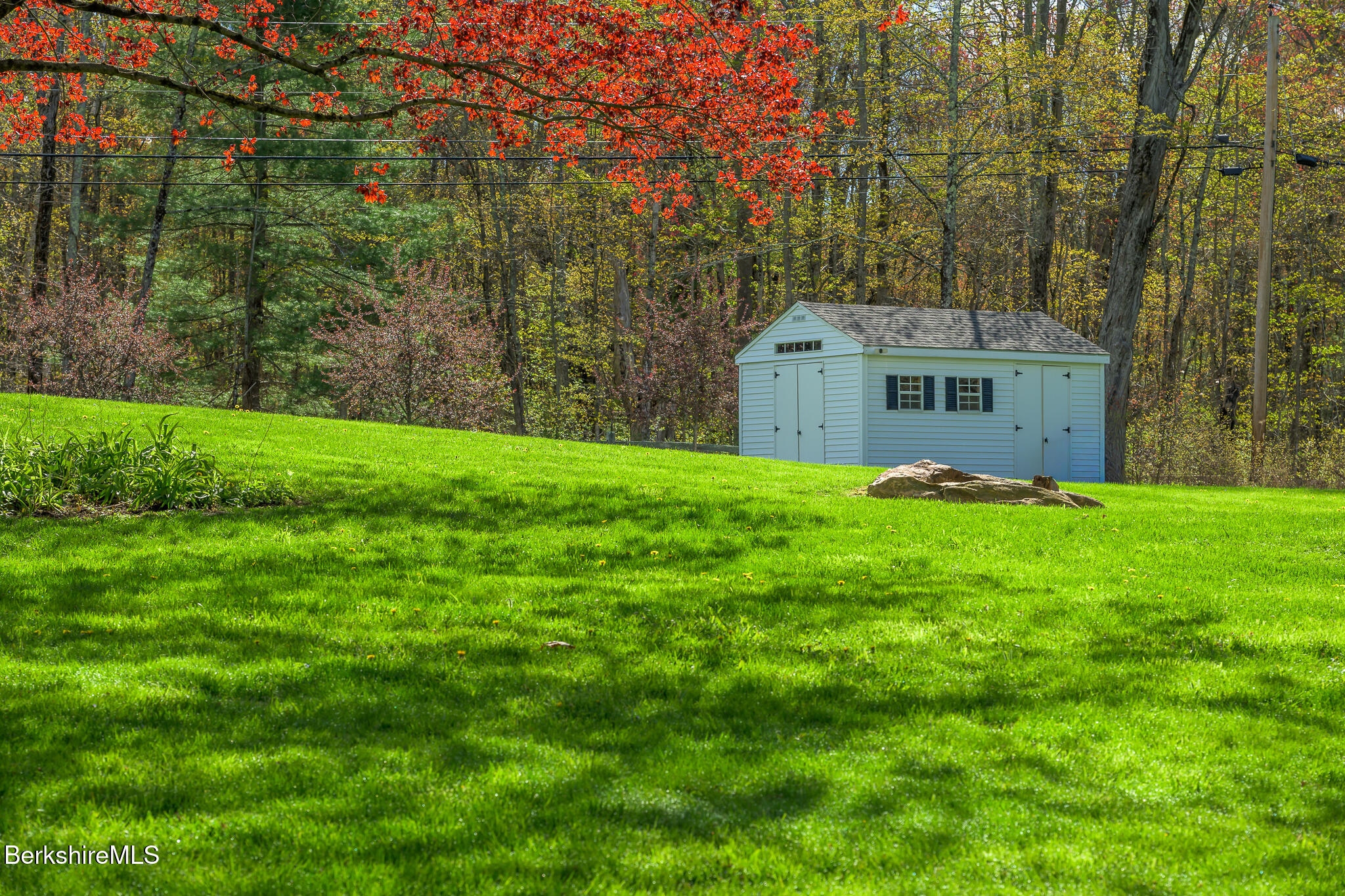 304 Hickey Hill Road Sheffield, MA 01257 - Photo 54 of 60 a house that is sitting in the grass with large trees