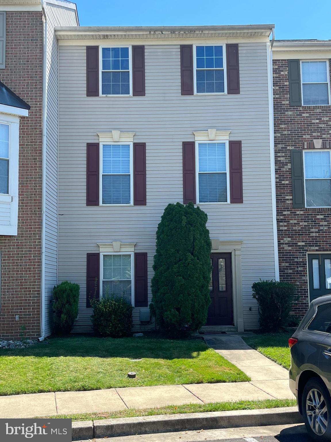 7541 Moraine Drive Hanover, MD 21076 - Photo 1 of 4 a view of a brick house with a yard and large windows