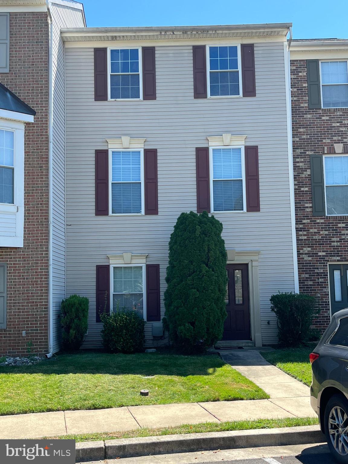 7541 Moraine Drive Hanover, MD 21076 - Photo 2 of 4 a view of a brick house with a yard and large windows