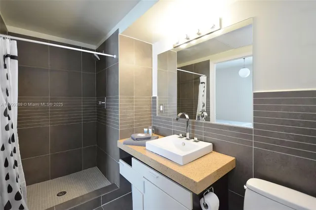 a bathroom with a sink toilet and shower